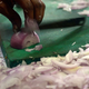 Close-up of chef's hands chopping onion on cutting board